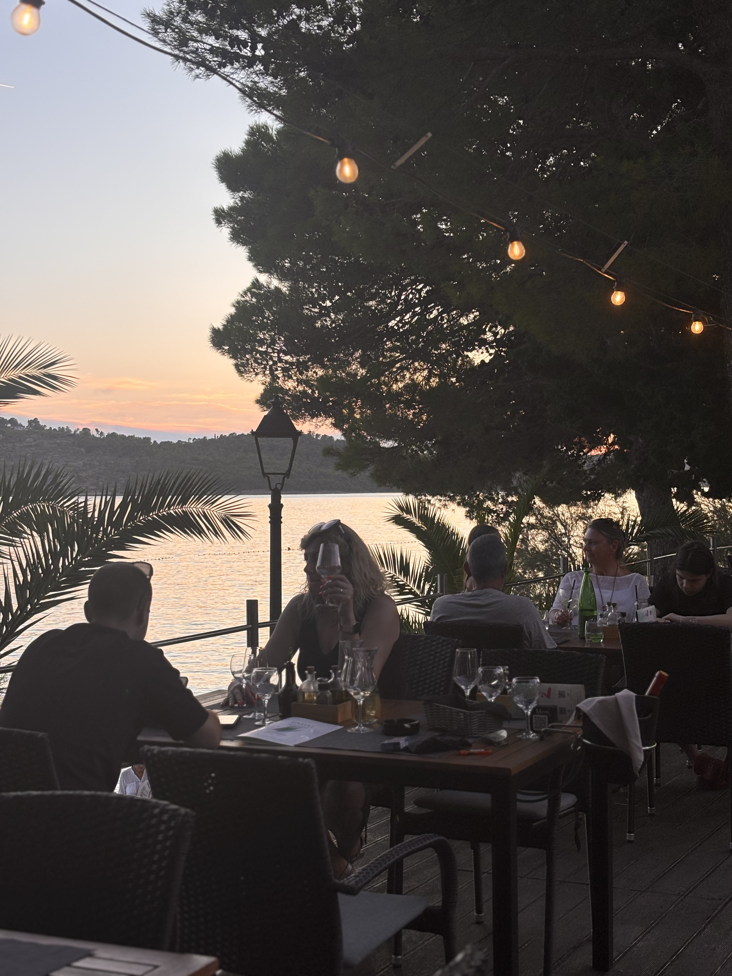 Guests dining on the Illyrian Restaurant terrace at sunset
