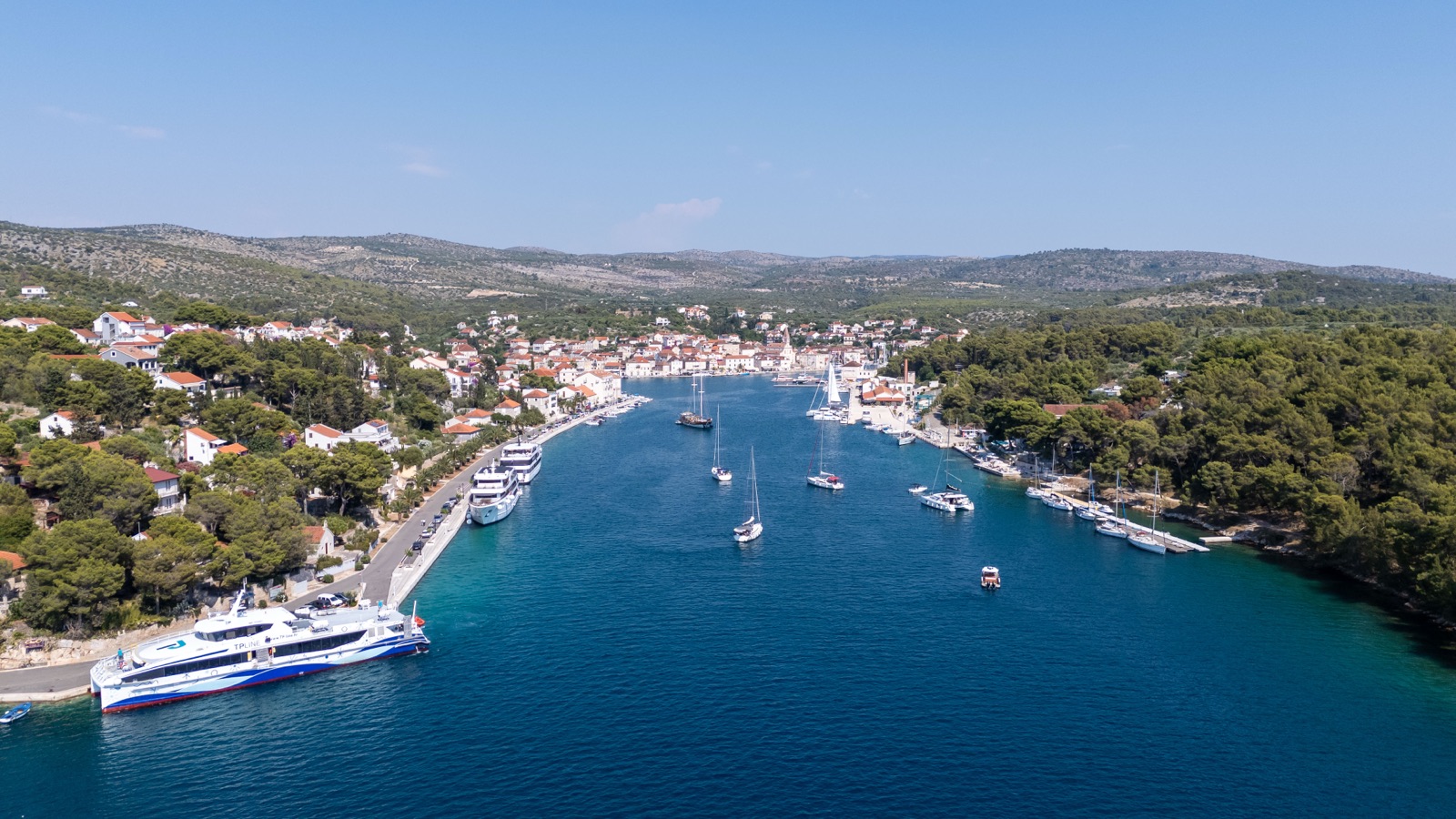 Aerial view of Milna harbour with sailboats and the ferry docked