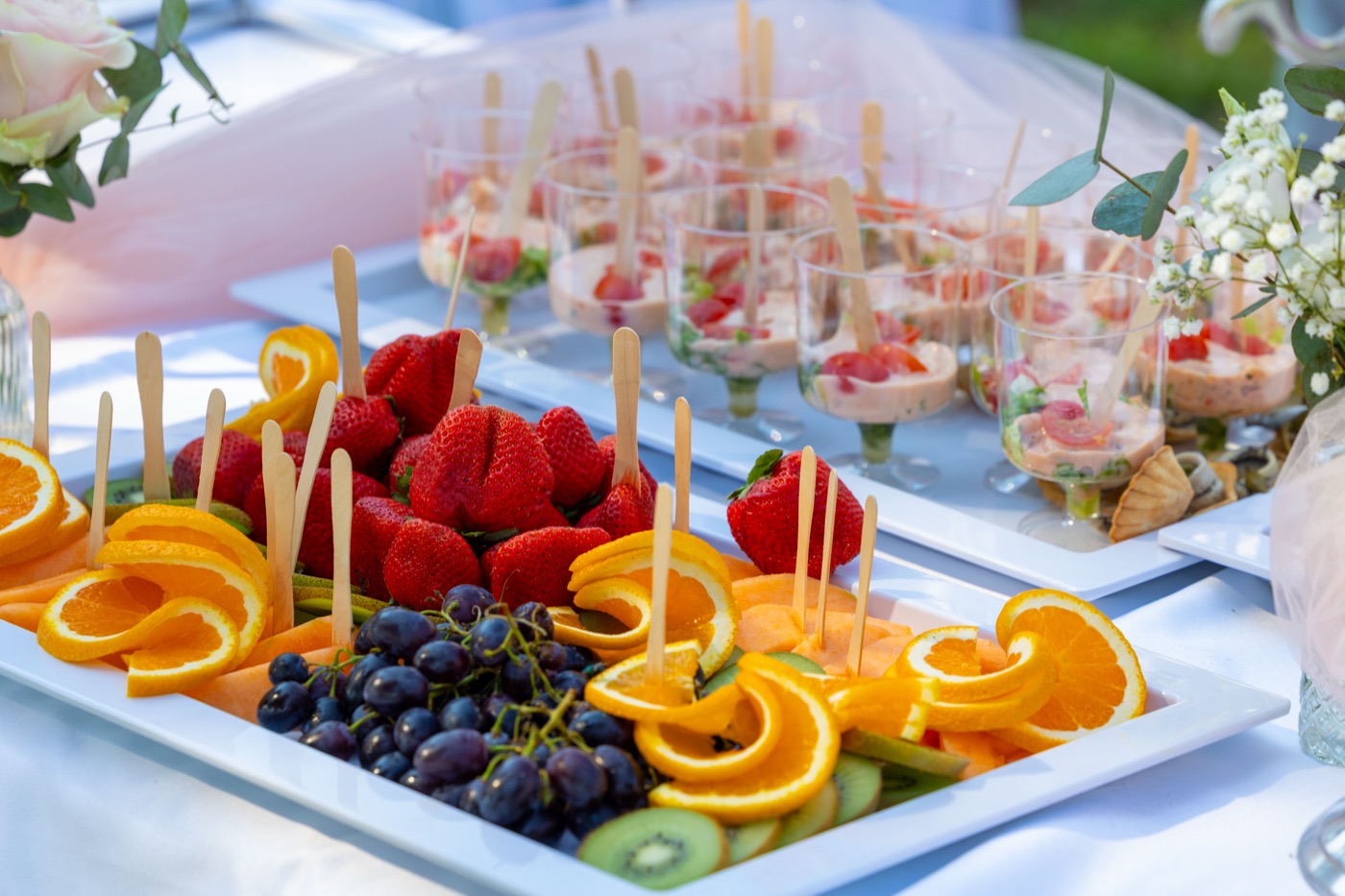 Fresh fruit skewers and appetizers on the catering table